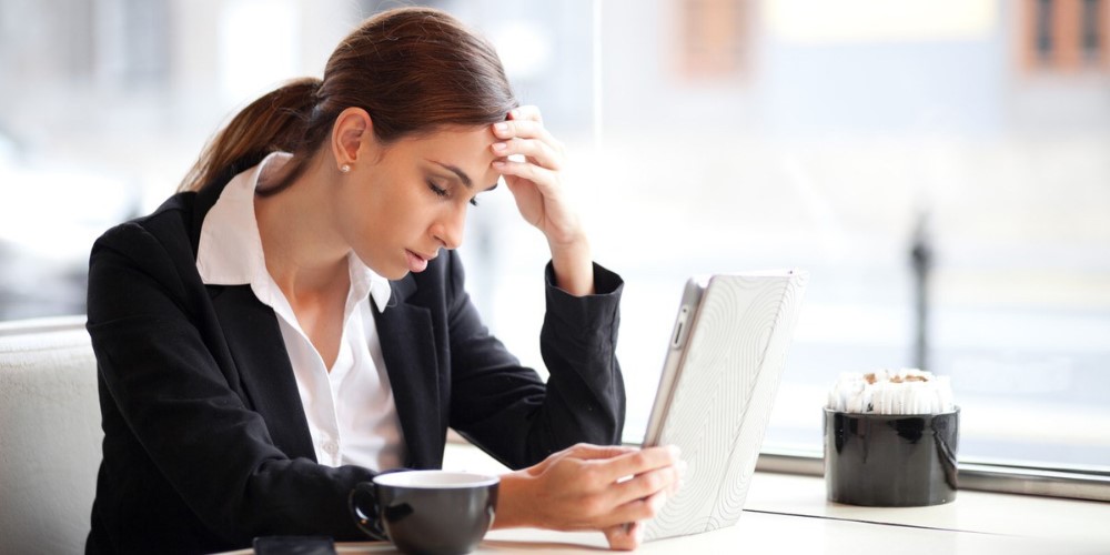 Woman looking upset whilst on computer